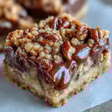 Golden-brown Decadent Sweet and Chewy Turtle Bars feature gooey caramel and rich chocolate.