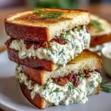 Elegant cucumber and cream cheese Benedictine tea sandwiches on white bread, garnished with fresh dill for a Southern Derby party.