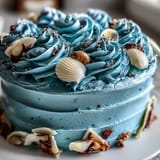 Moist vanilla Cancer Zodiac Cake, adorned with sparkling edible shells, ready for serving.