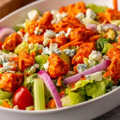 Vibrant Buffalo Chicken Chopped Salad tossed with celery, red onion, and tangy ranch dressing.  