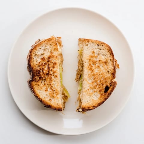 Toasted sourdough bread reveals sweet, savory Havarti & Caramelized Leek Grilled Cheese filling.