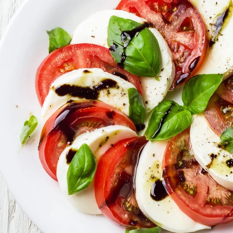 The simple elegance of Caprese salad, perfect as a light appetizer with fresh olive oil.
