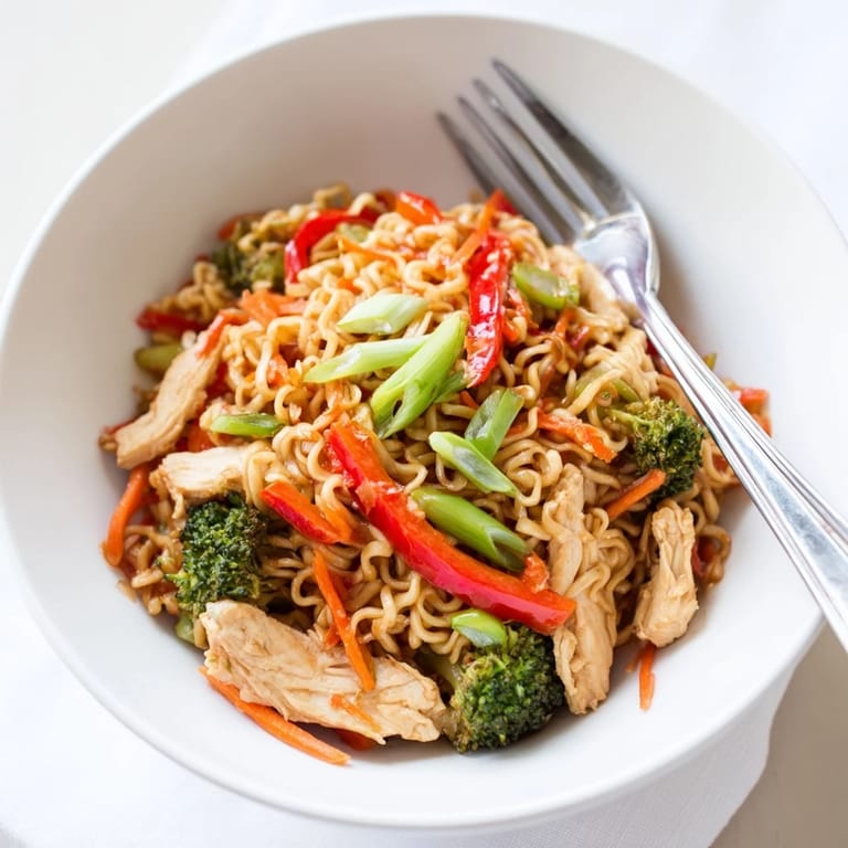 A sizzling pan of Spicy Ramen Stir-Fry with tender chicken and crisp vegetables, ready for a quick weeknight dinner.